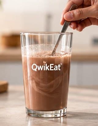 Water and QwikEat being mixed with a spoon in a clear glass